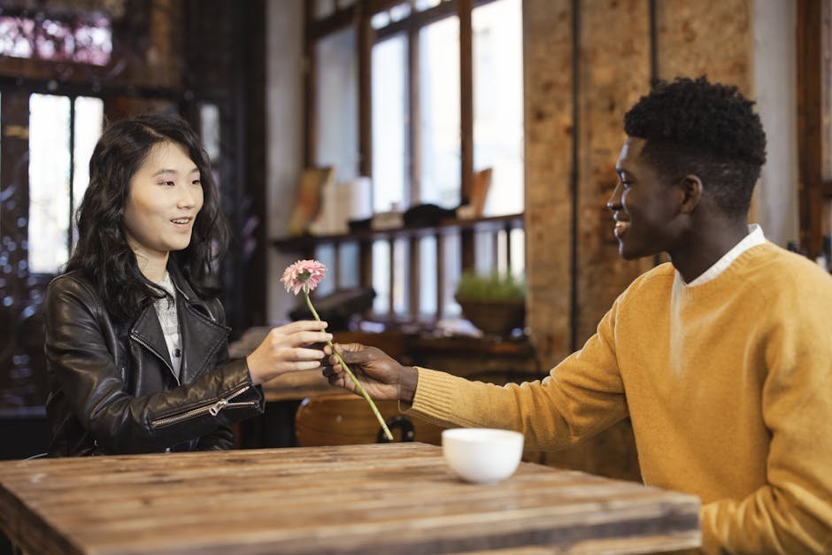 A warm scene of a couple exchanging a flower over a table in a cozy café, symbolizing connection.