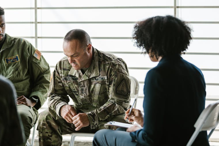 A therapy session for military veterans focusing on mental health and PTSD support.